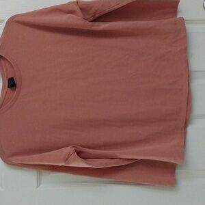 An REI Cooperative peach tee shirt.  Size Medium.
